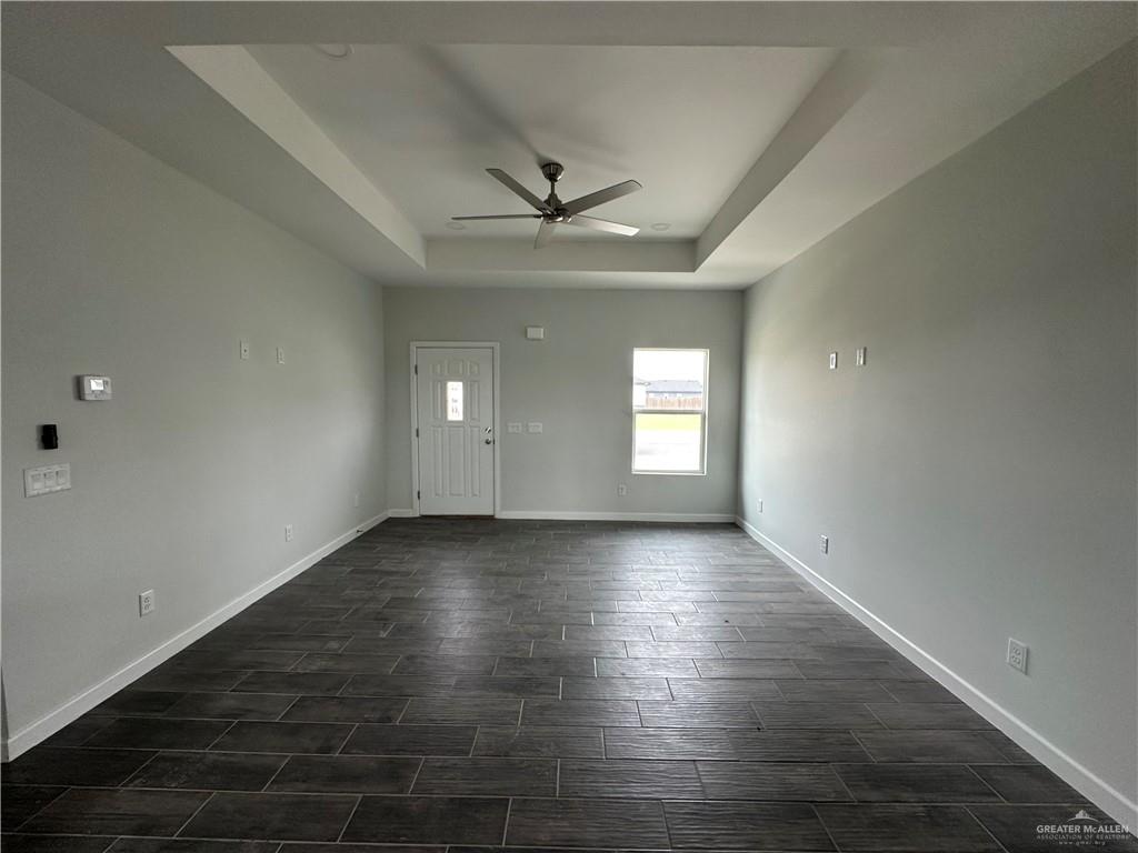 1802 Unity Drive Mercedes, TX 78570 - Photo 2 of 11 an empty room with wooden floor and windows