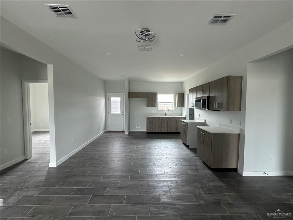 1802 Unity Drive Mercedes, TX 78570 - Photo 3 of 11 a view of a living room with kitchen furniture and a wooden floor