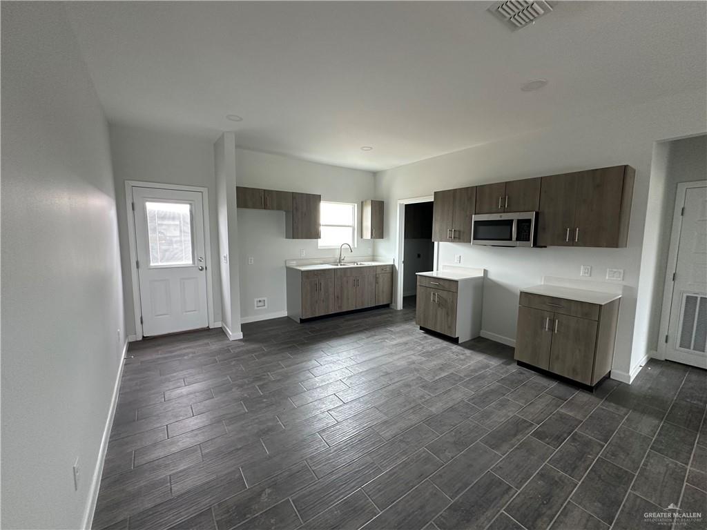 1802 Unity Drive Mercedes, TX 78570 - Photo 4 of 11 a view of a kitchen with microwave and cabinets