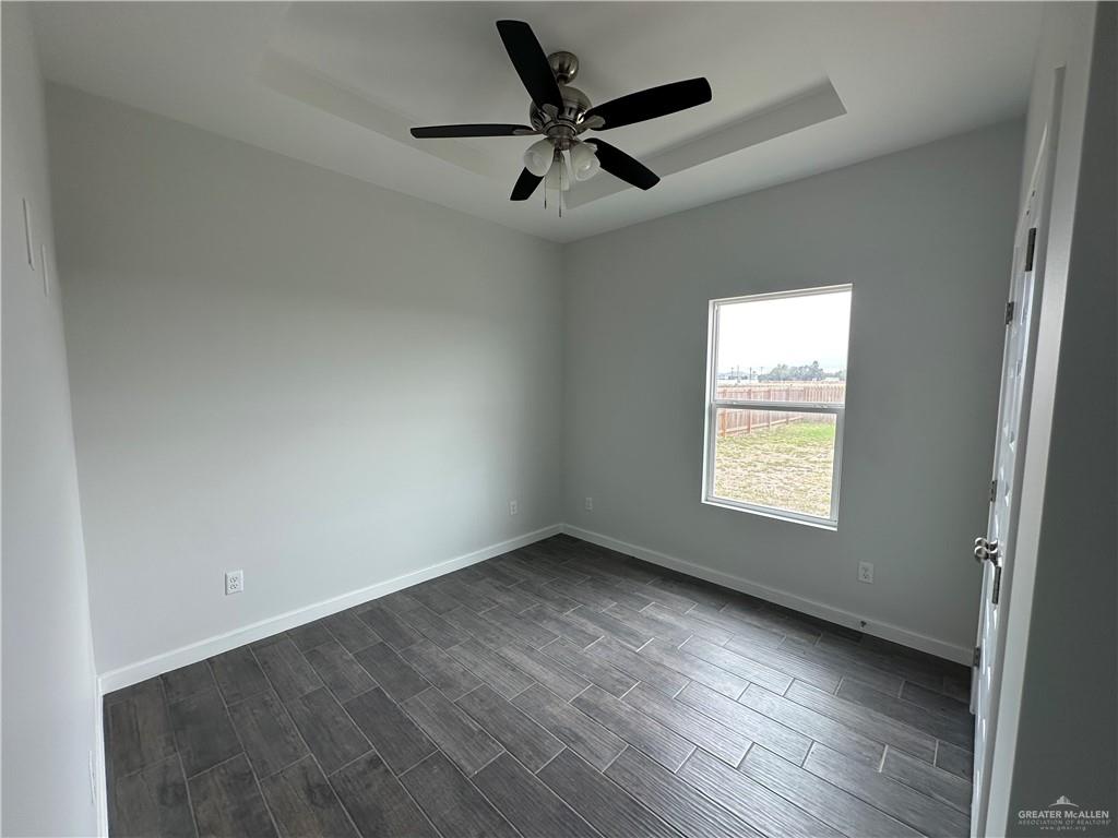 1802 Unity Drive Mercedes, TX 78570 - Photo 6 of 11 an empty room with wooden floor and windows