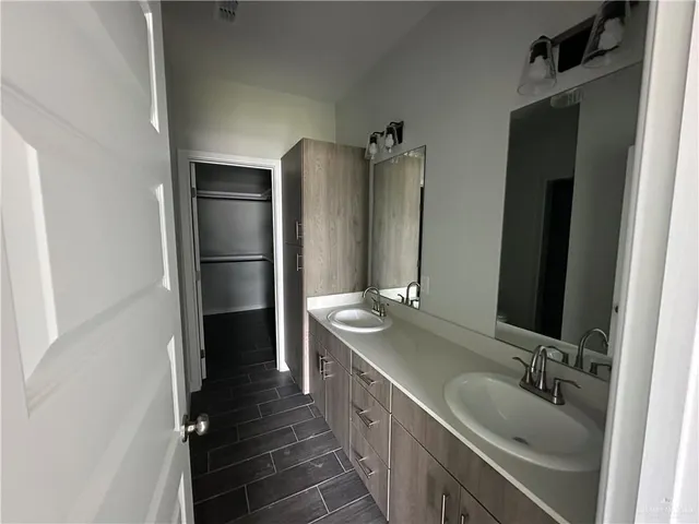 a bathroom with a double vanity sink and mirror