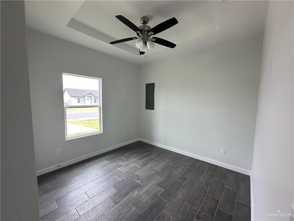 1802 Unity Drive Mercedes, TX 78570 - Photo 8 of 11 an empty room with window and ceiling fan