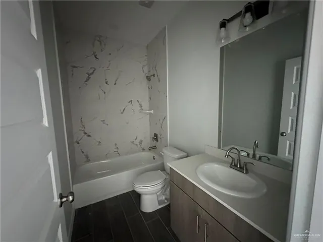 a bathroom with a sink toilet vanity and shower