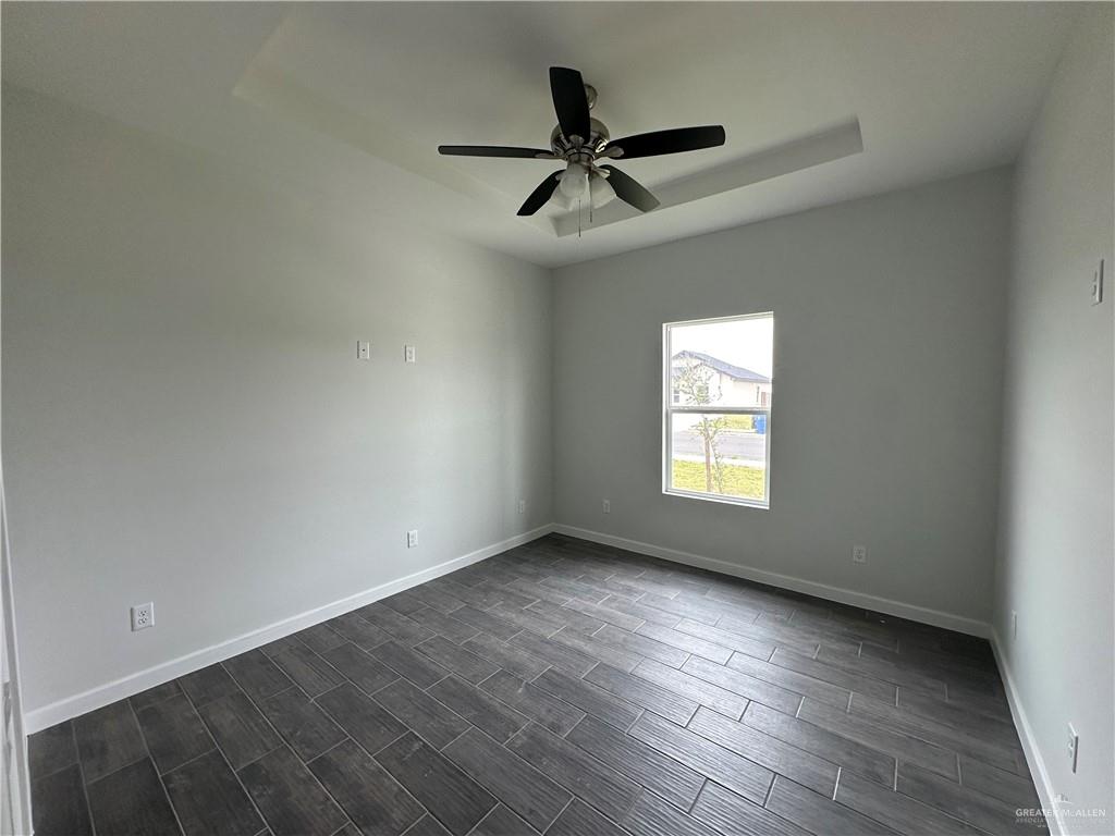 1802 Unity Drive Mercedes, TX 78570 - Photo 10 of 11 wooden floor in an empty room with a window
