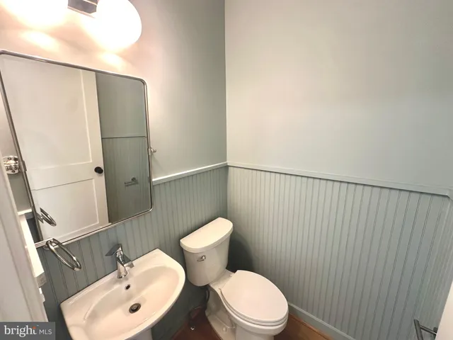 a white toilet sitting next to a bathroom sink