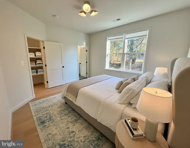 a spacious bedroom with a bed and a window