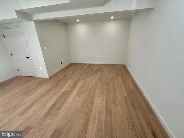 a view of a room with wooden floor