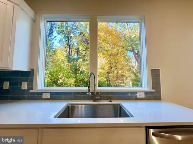 a kitchen with a sink and a large window