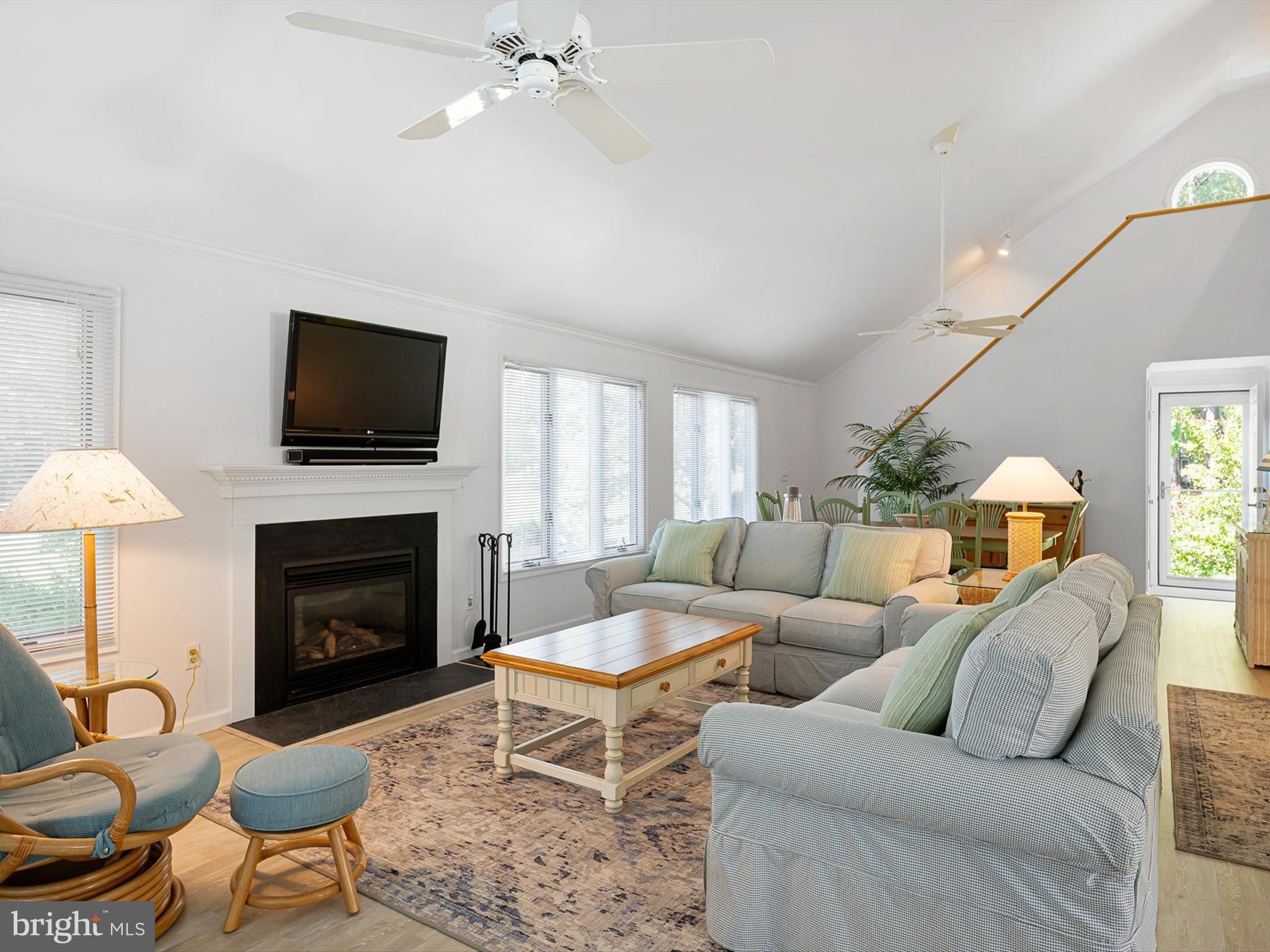 532 Bethany Loop Bethany Beach, DE 19930 - Photo 15 of 65 a living room with furniture a fireplace and a flat screen tv