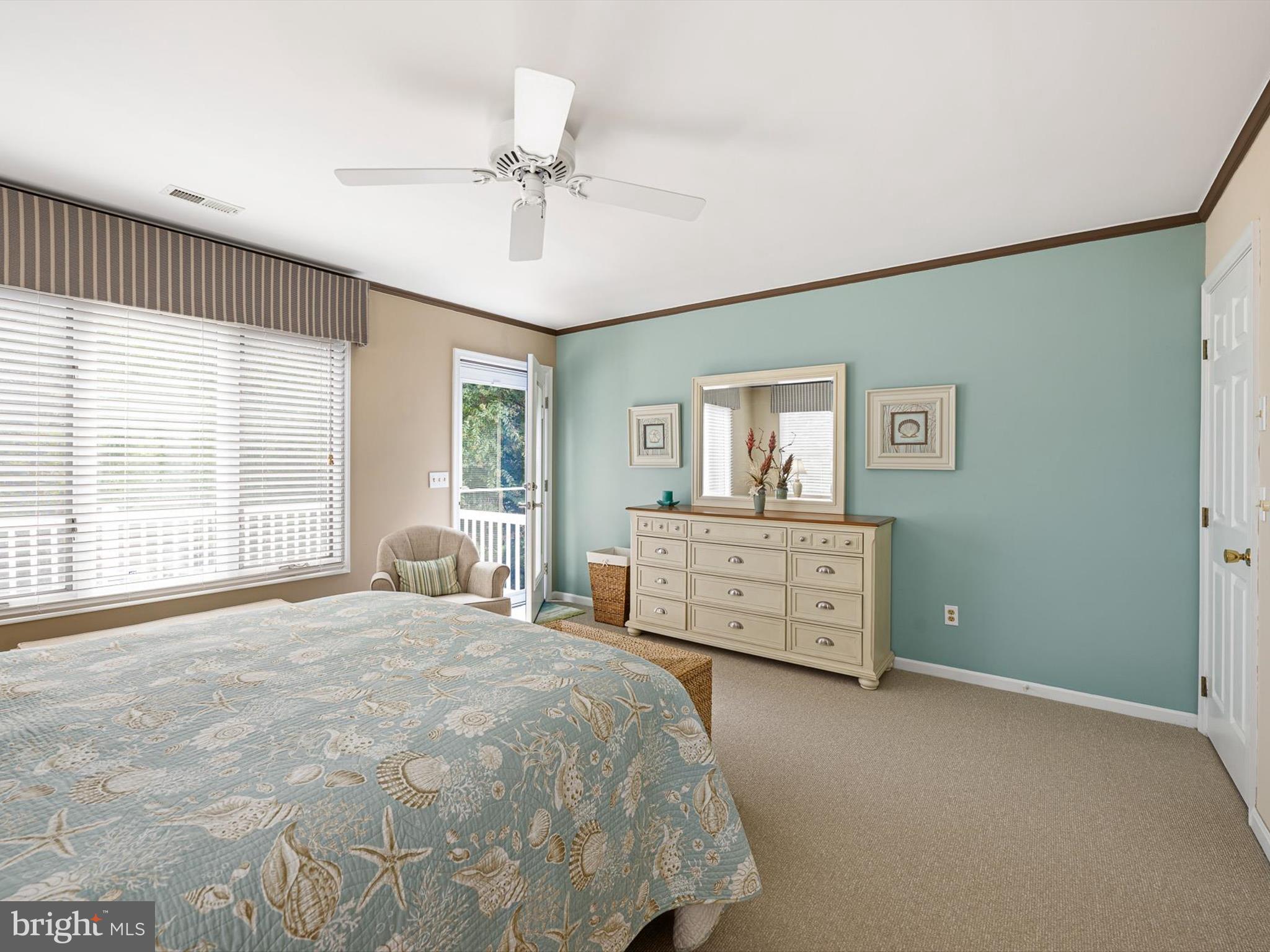 532 Bethany Loop Bethany Beach, DE 19930 - Photo 33 of 65 a bedroom with a large bed and a chandelier