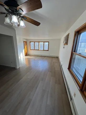 a view of entryway and hall with wooden floor