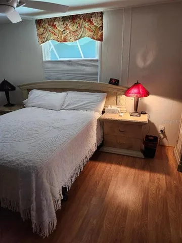 a bedroom with a bed and flat screen tv