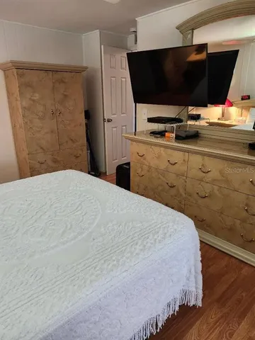 a living room with a couch wooden floor and furniture