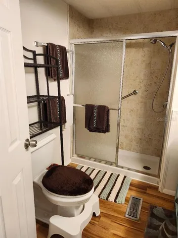 a bedroom with a bed and a mirror