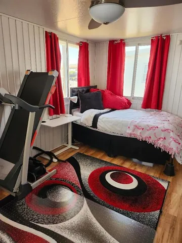 a living room with furniture a window and gym equipment