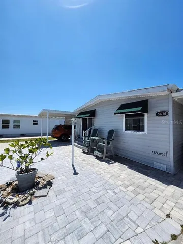 a view of a chairs and table in backyard