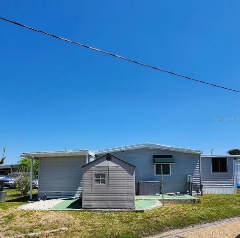 a swimming pool with outdoor seating and yard
