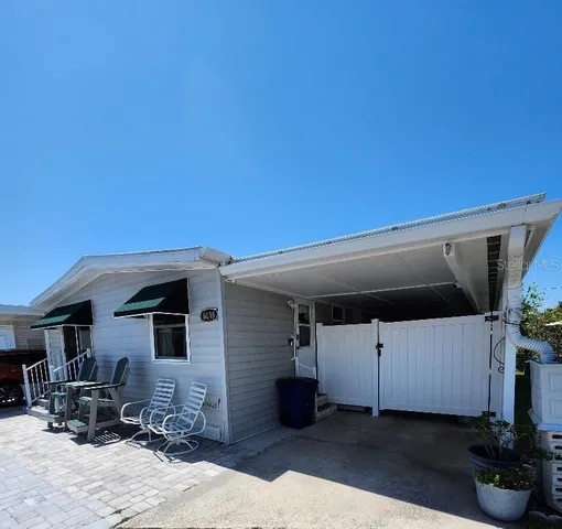 a front view of a house with sitting area