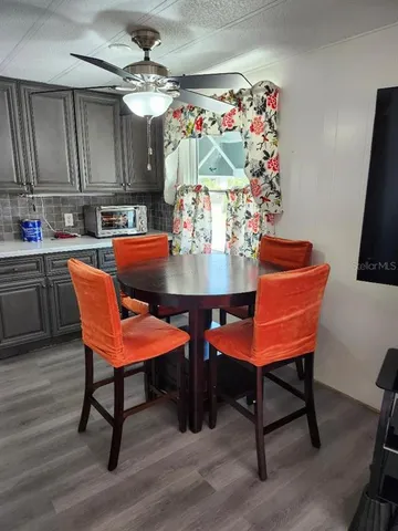 a view of a dining room with furniture and chandelier