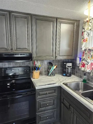 a kitchen with sink and cabinets