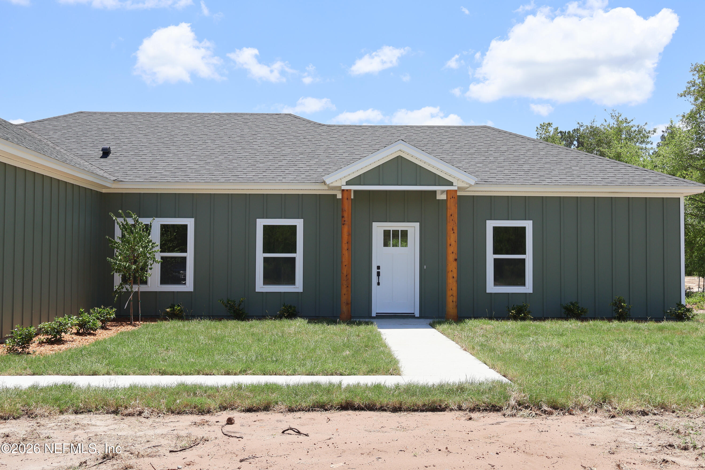 261121 Rowe Road Hilliard, FL 32046 - Photo 2 of 33 a front view of a house with a garden