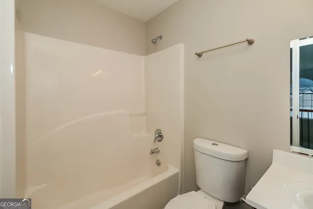 a bathroom with a toilet and a bathtub