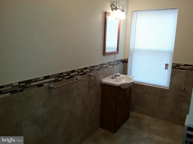 a bathroom with a sink and mirror