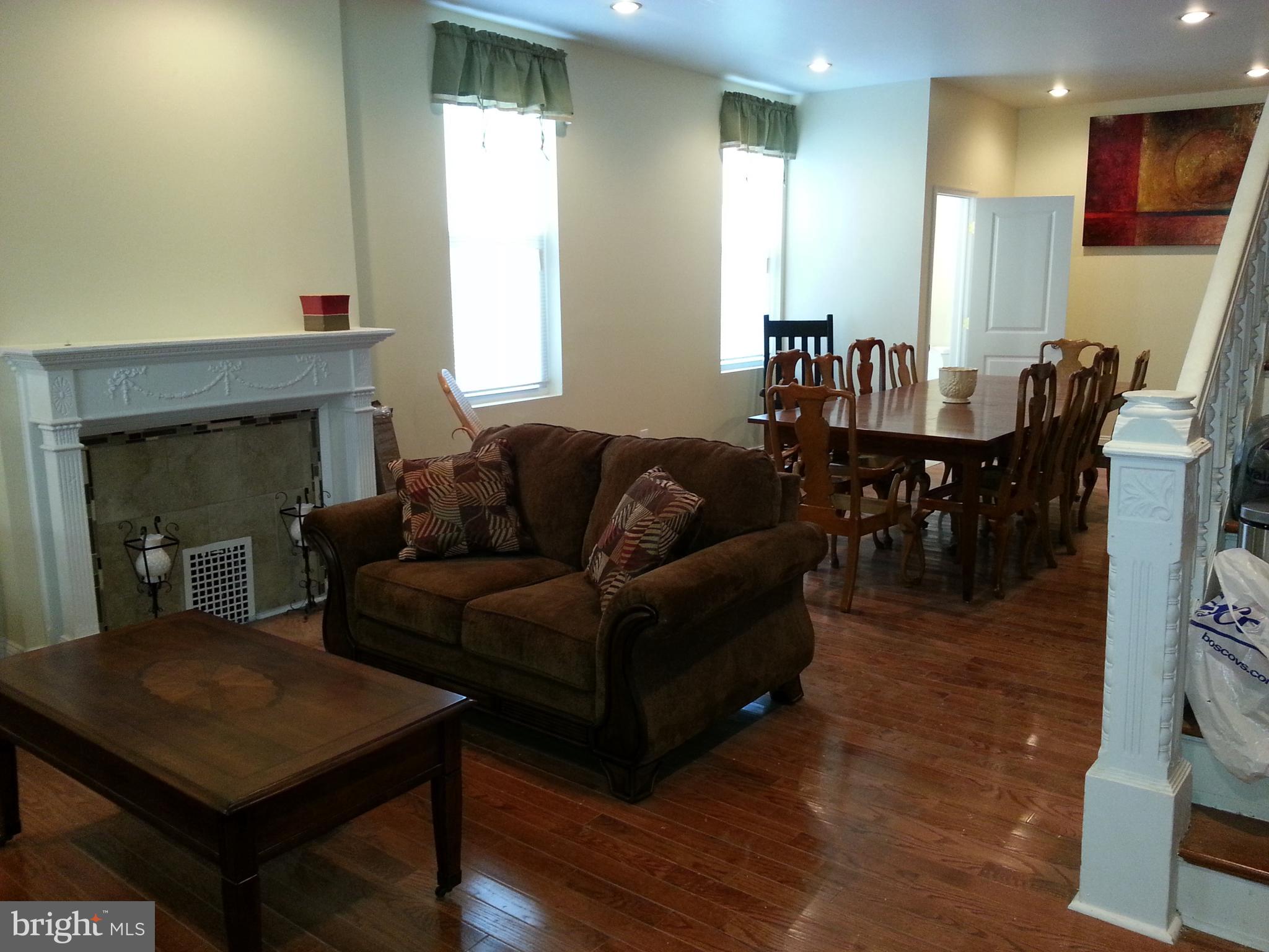 500 North 39th Street Philadelphia, PA 19104 - Photo 24 of 26 a living room with furniture a dining table and a fireplace