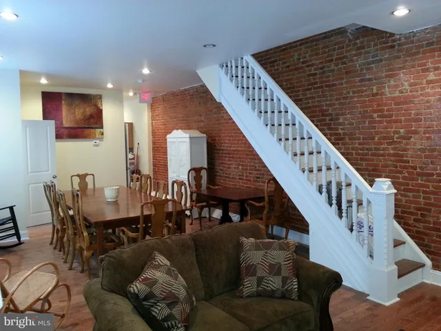 a living room with furniture and stairs
