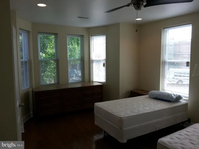 a bedroom with a bed and window