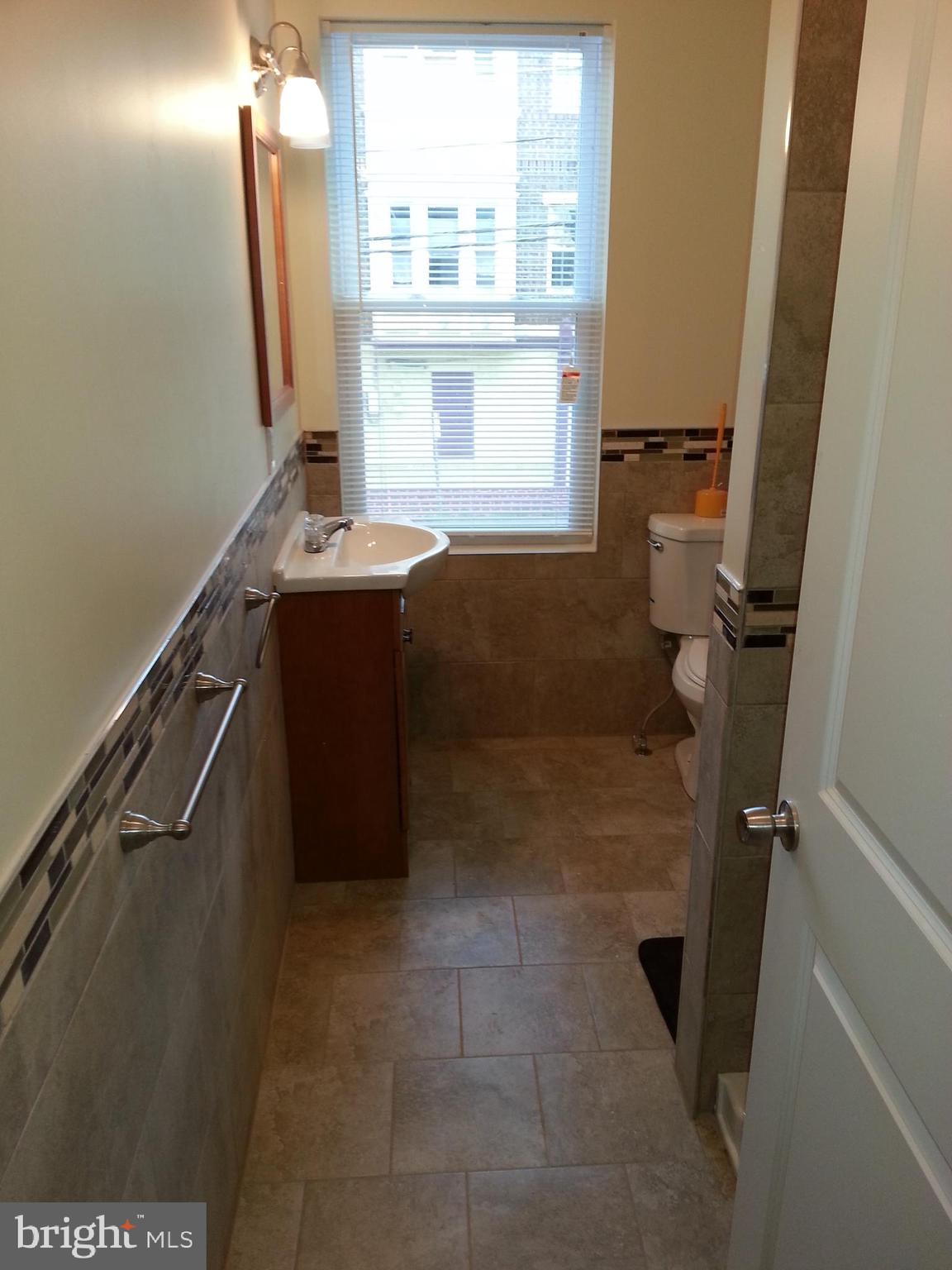 500 North 39th Street Philadelphia, PA 19104 - Photo 9 of 26 a bathroom with a sink a mirror and a shower