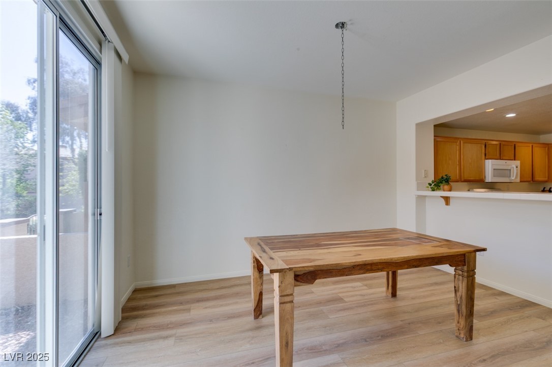 10220 Delray Beach Avenue, Unit 103 Las Vegas, NV 89129 - Photo 15 of 42 Unfurnished dining area with baseboards, recessed lighting, and light wood finished floors