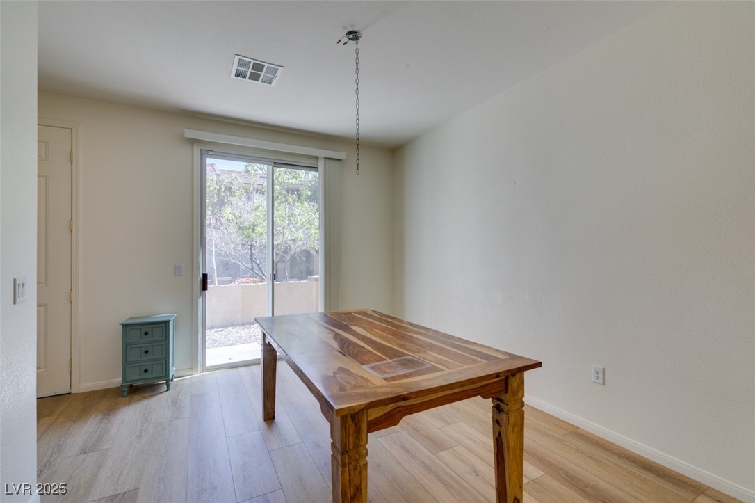 10220 Delray Beach Avenue, Unit 103 Las Vegas, NV 89129 - Photo 18 of 42 Dining space featuring light wood finished floors, baseboards, and visible vents