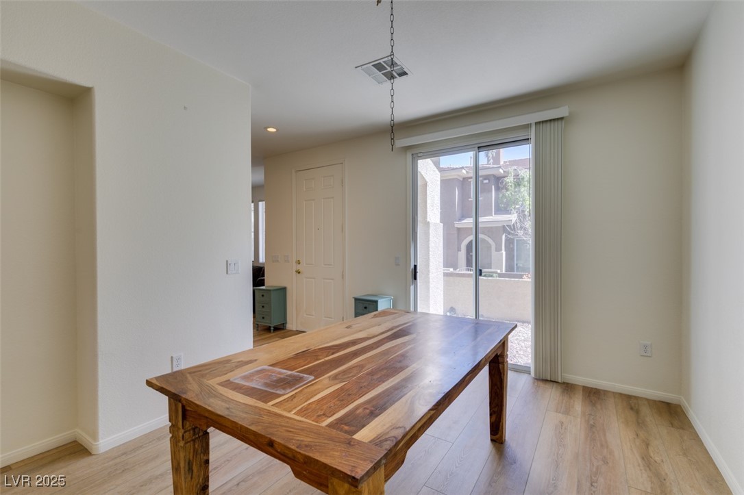 10220 Delray Beach Avenue, Unit 103 Las Vegas, NV 89129 - Photo 19 of 42 Dining area featuring baseboards, light wood finished floors, and visible vents