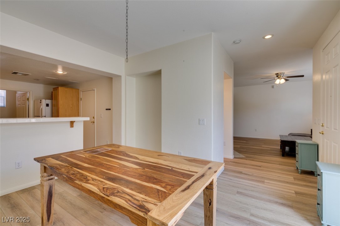 10220 Delray Beach Avenue, Unit 103 Las Vegas, NV 89129 - Photo 20 of 42 Dining room with visible vents, baseboards, recessed lighting, a ceiling fan, and light wood-type flooring