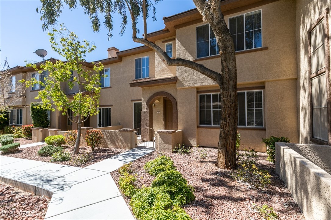 10220 Delray Beach Avenue, Unit 103 Las Vegas, NV 89129 - Photo 2 of 42 View of front of property with stucco siding, a gate, and a fenced front yard