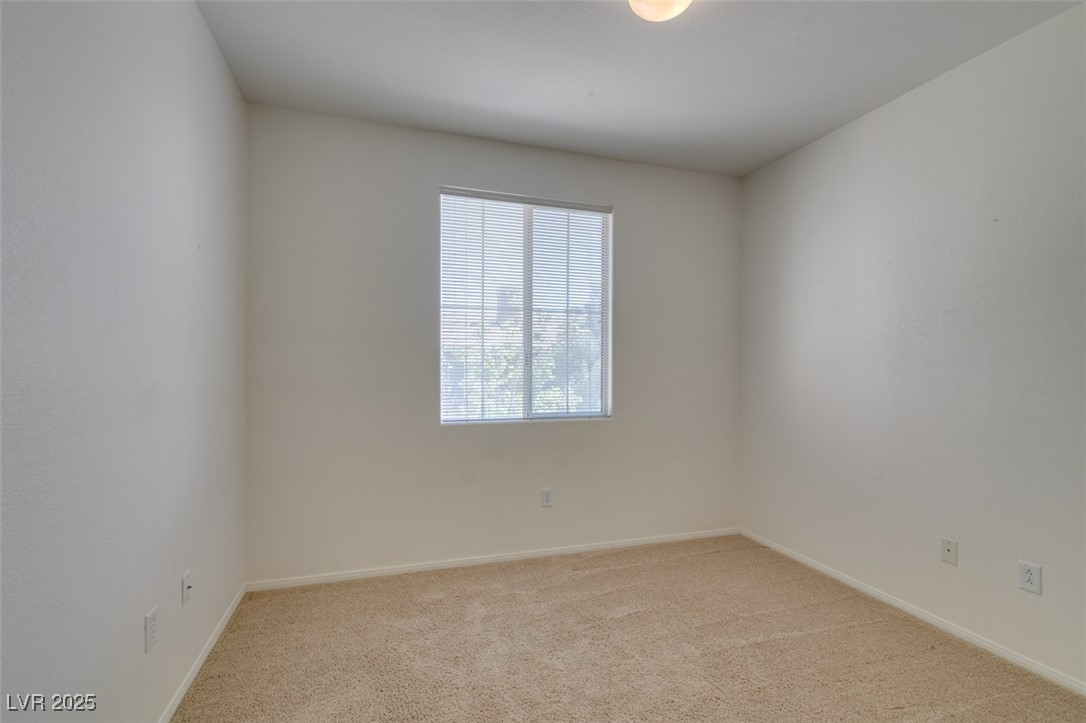 10220 Delray Beach Avenue, Unit 103 Las Vegas, NV 89129 - Photo 29 of 42 Carpeted spare room featuring baseboards