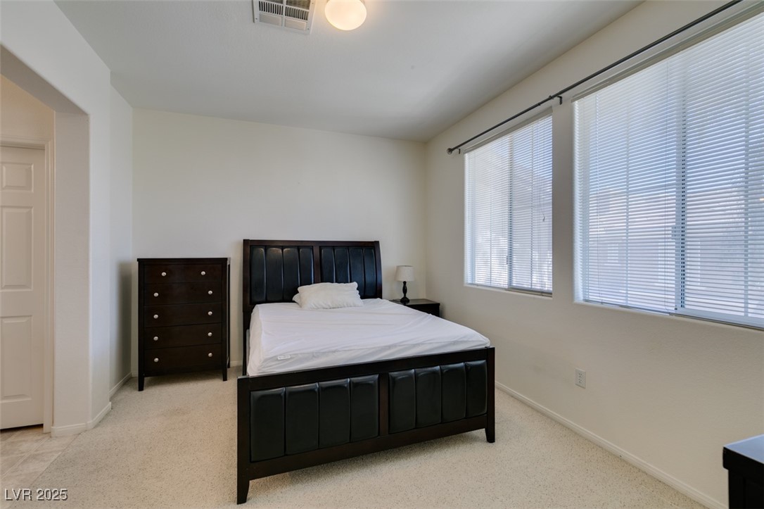 10220 Delray Beach Avenue, Unit 103 Las Vegas, NV 89129 - Photo 33 of 42 Bedroom featuring baseboards, visible vents, and carpet