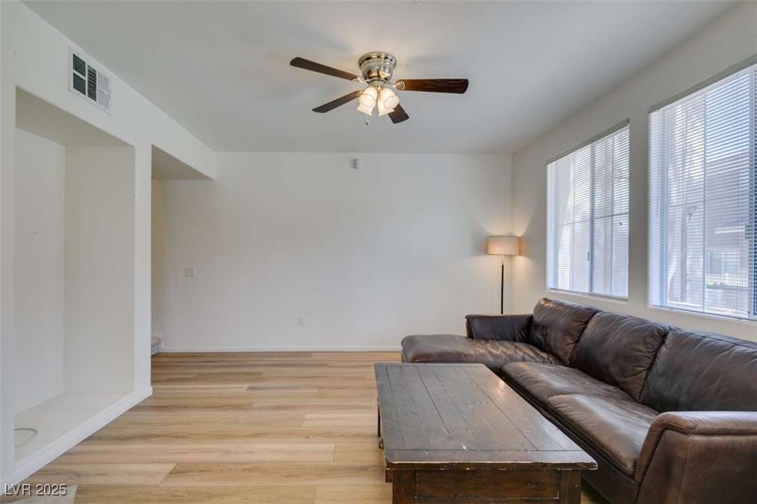 10220 Delray Beach Avenue, Unit 103 Las Vegas, NV 89129 - Photo 6 of 42 Living room featuring baseboards, ceiling fan, visible vents, and light wood-style floors