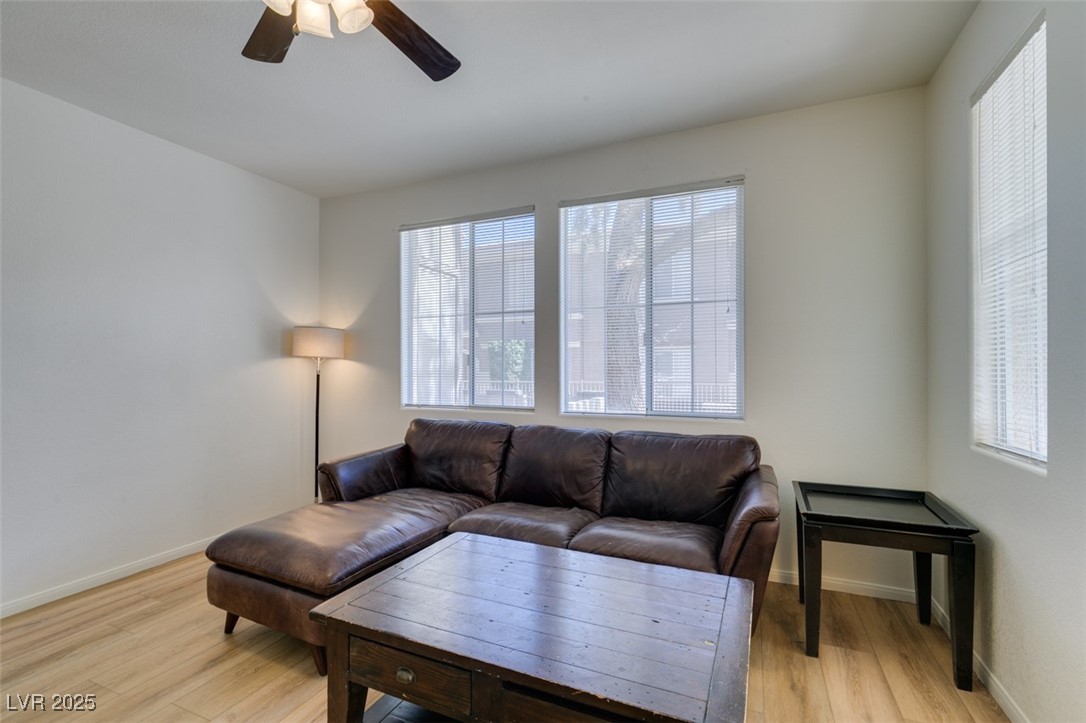 10220 Delray Beach Avenue, Unit 103 Las Vegas, NV 89129 - Photo 7 of 42 Living area featuring a ceiling fan, baseboards, and light wood-type flooring