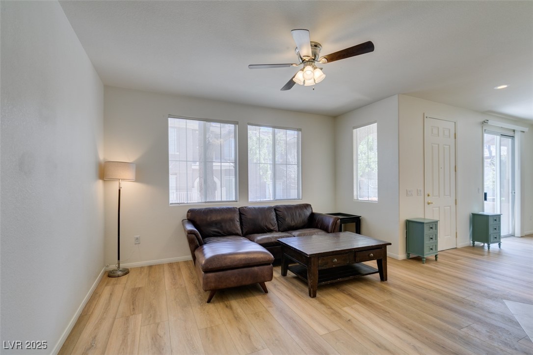 10220 Delray Beach Avenue, Unit 103 Las Vegas, NV 89129 - Photo 9 of 42 Living area featuring baseboards, light wood-style floors, and ceiling fan