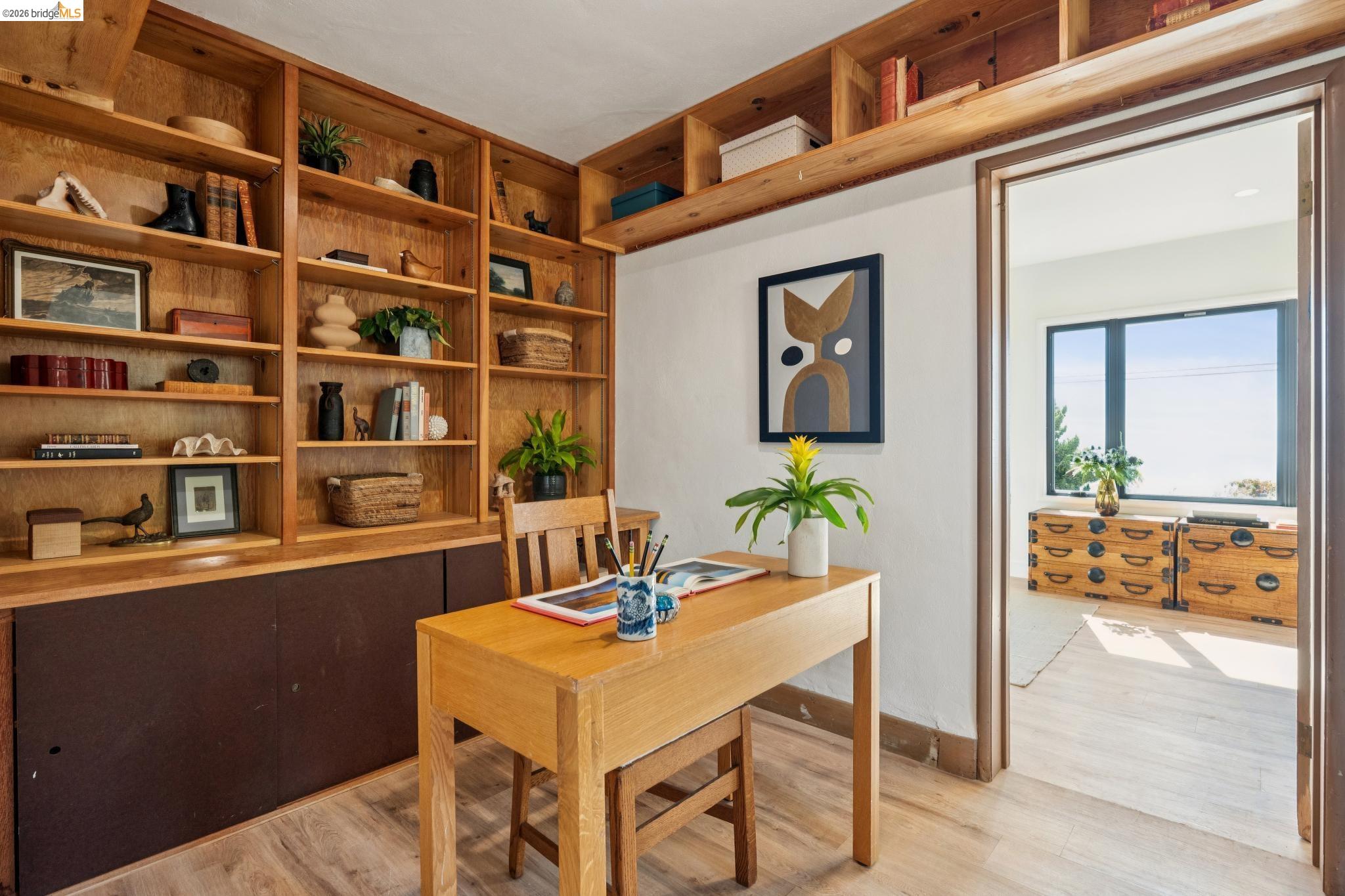 38 Highgate Road Kensington, CA 94707 - Photo 48 of 78 Built-in wood shelving, wood-finish flooring, and a wood-frame doorway