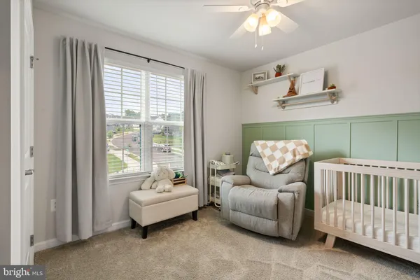 a bedroom with a bed chandelier and a window
