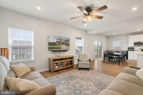 a kitchen with kitchen island a stove a sink a center island and wooden floor
