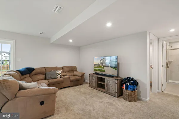 a bathroom with a granite countertop sink mirror and toilet