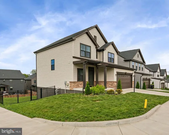 a view of house with a big yard and table and chairs