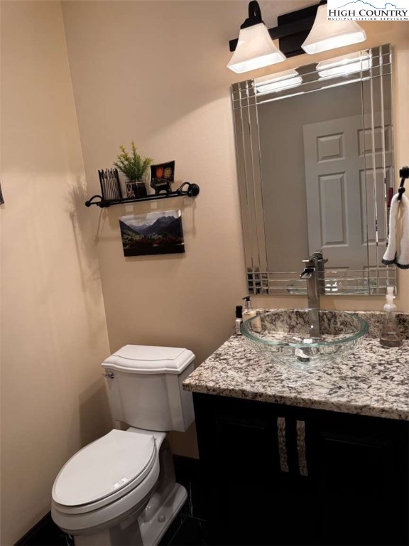 167 Elliott Circle, Unit D1 Blowing Rock, NC 28605 - Photo 12 of 25 a bathroom with a granite countertop toilet sink and mirror