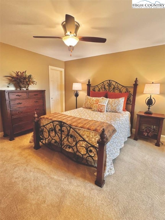 167 Elliott Circle, Unit D1 Blowing Rock, NC 28605 - Photo 13 of 25 a bedroom with a bed and a chandelier