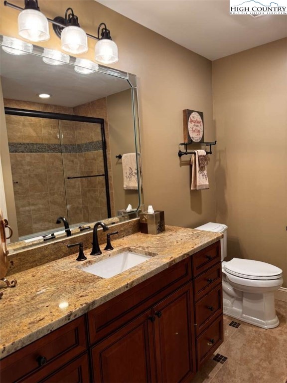 167 Elliott Circle, Unit D1 Blowing Rock, NC 28605 - Photo 15 of 25 a bathroom with a granite countertop sink a toilet and mirror