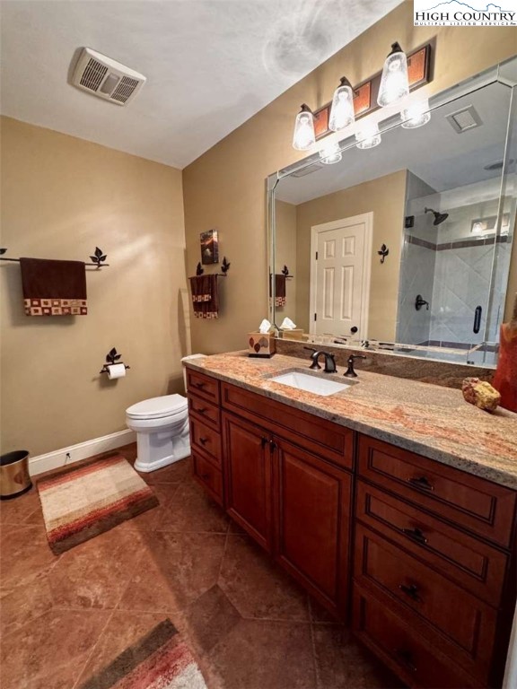 167 Elliott Circle, Unit D1 Blowing Rock, NC 28605 - Photo 20 of 25 a bathroom with a granite countertop sink mirror and toilet